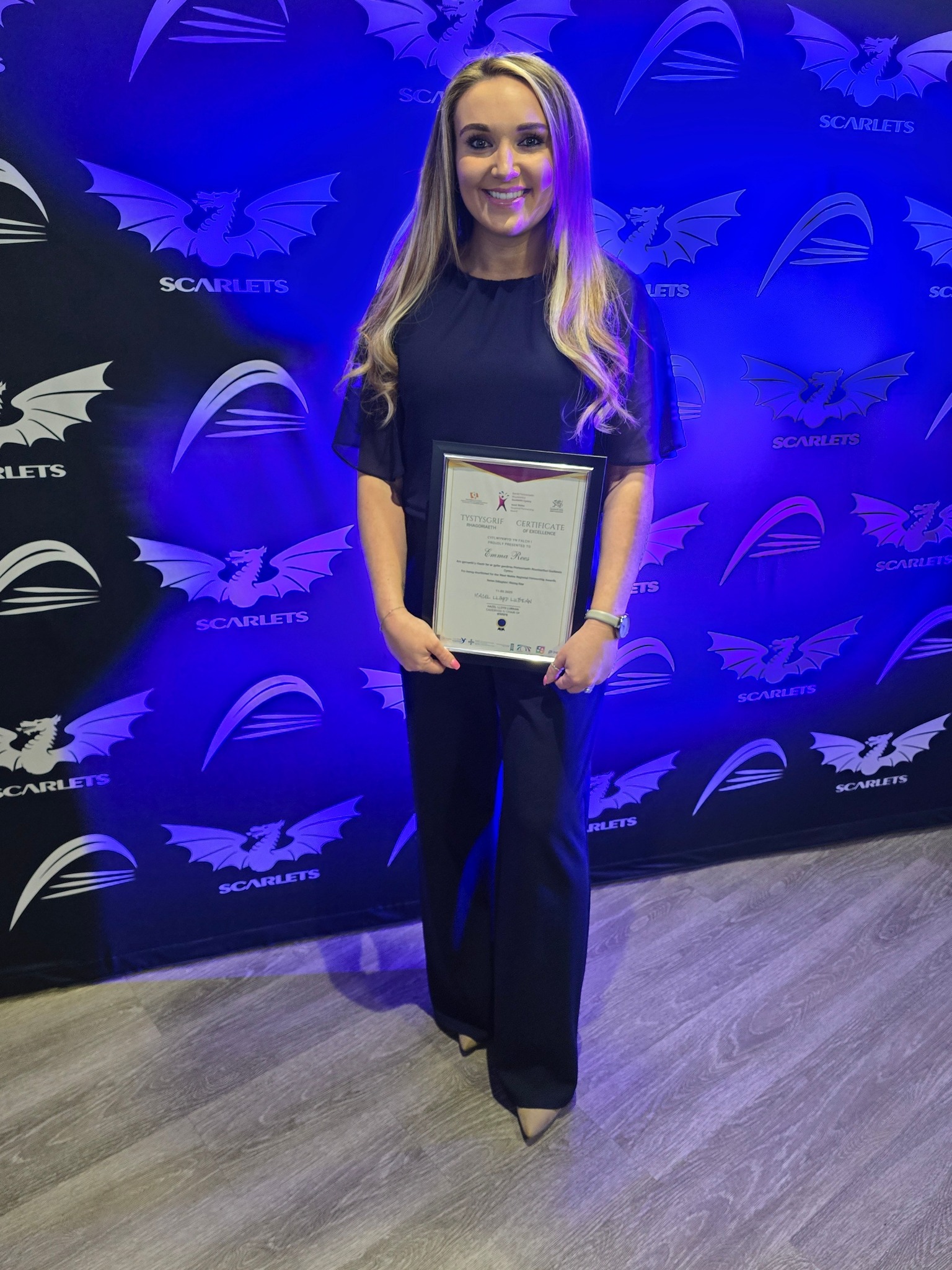 Emma collecting an award